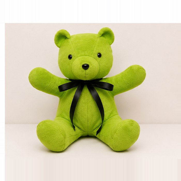 Green fleece memory bear with a black ribbon