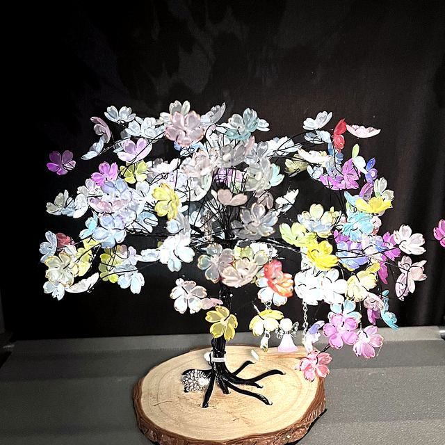 Pastel memory tree with multicoloured blossoms on a wooden slice base